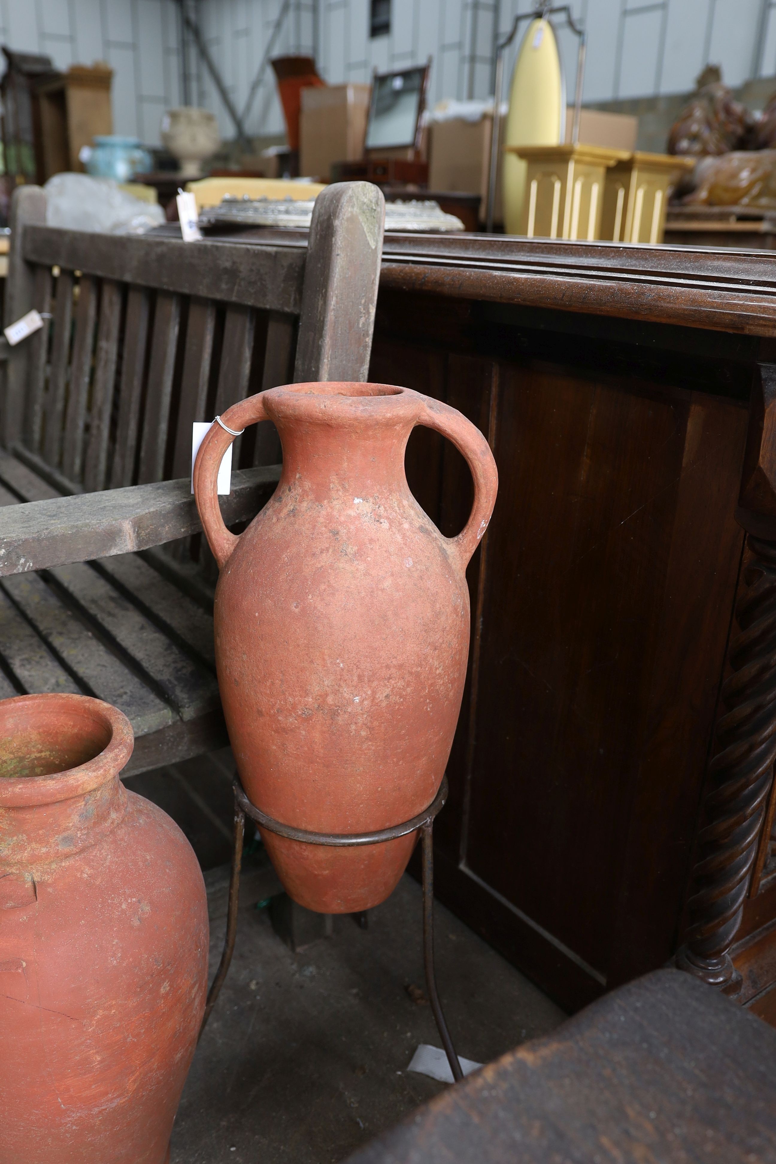 Two Greek style terracotta garden urns, one with iron stand, together with twelve assorted terracotta garden planters